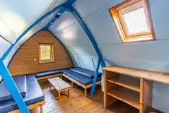 Camping pod interior- benches with comfy mattresses for sleeping and sitting