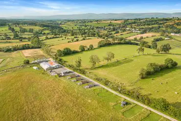 Aerial of the glamping pods and campsite in the centre of the organic farm