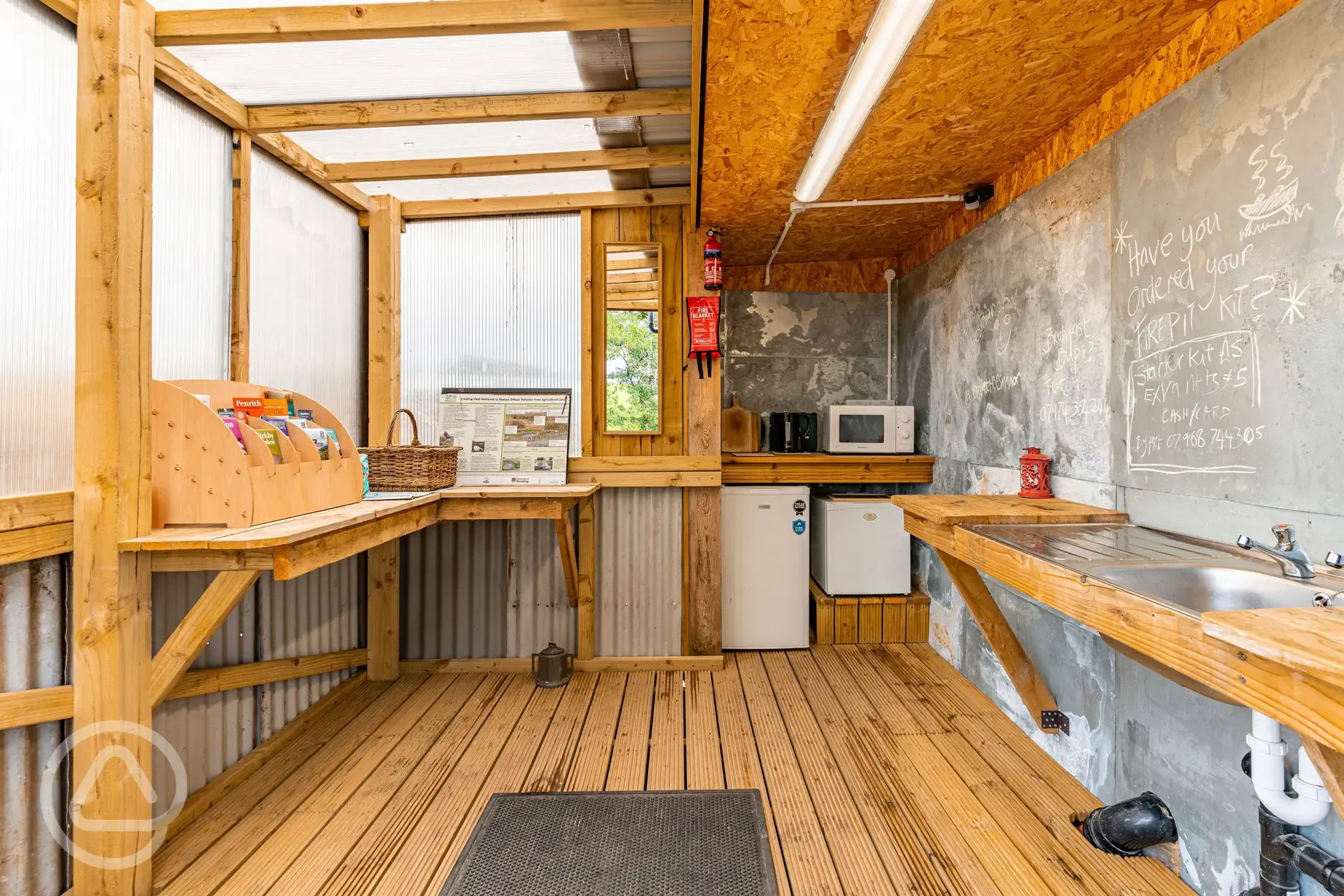 Community kitchen area with hot water, kettles, microwave, fridge and freezer