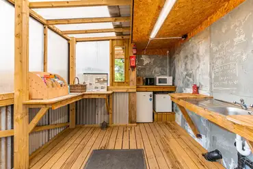 Community kitchen area with hot water, kettles, microwave, fridge and freezer