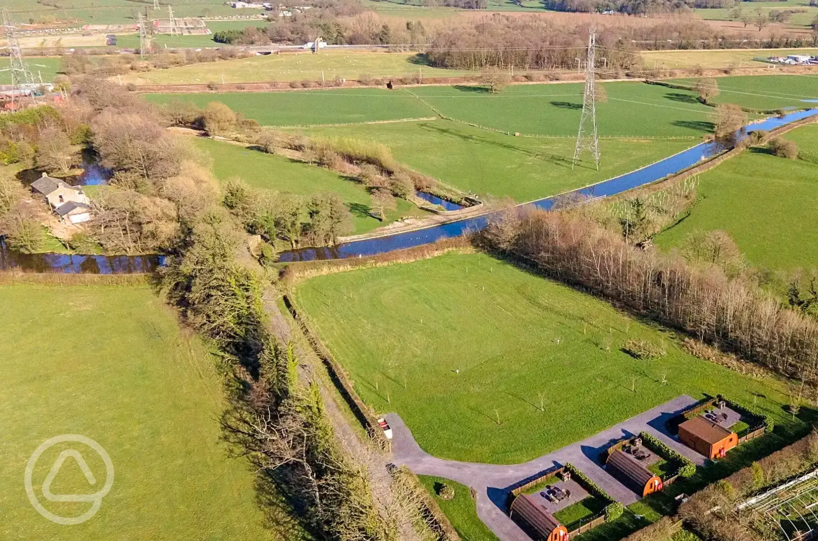 Aerial of the glamping pods, countryside and Lancaster Canal