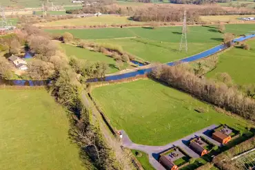 Aerial of the glamping pods, countryside and Lancaster Canal