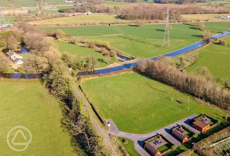 Aerial of the glamping pods, countryside and Lancaster Canal