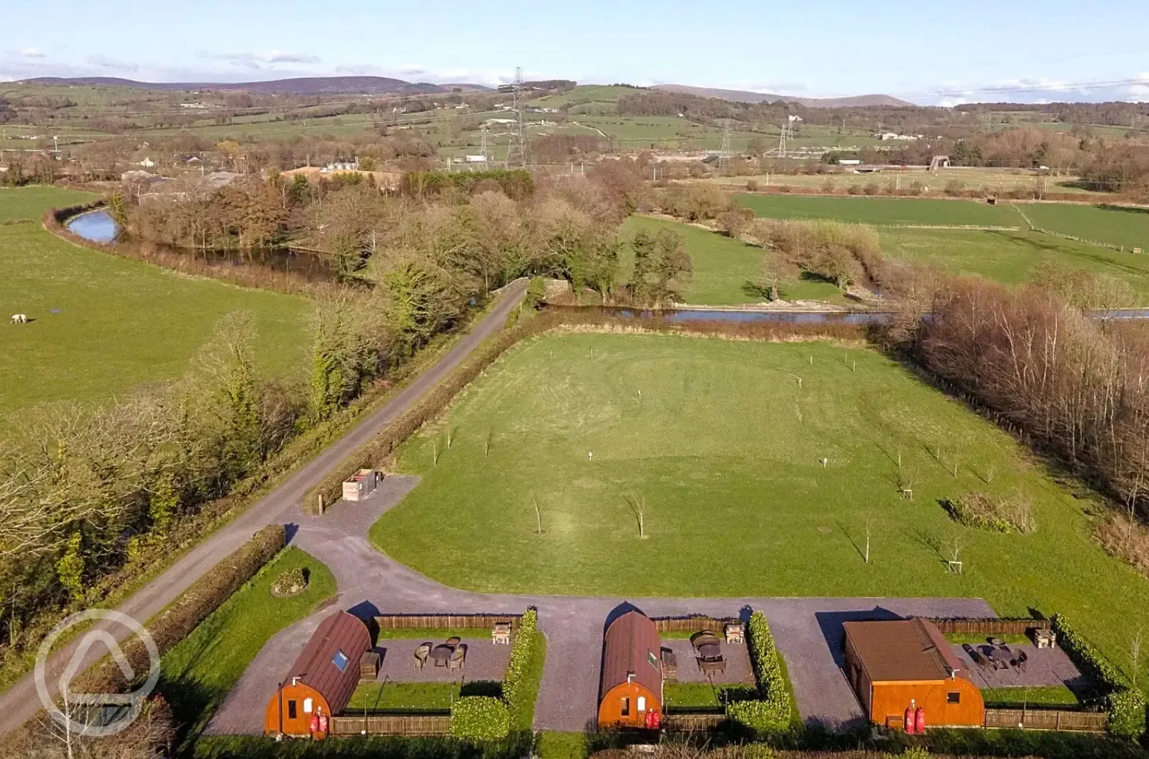 Aerial of the glamping pods, countryside and Lancaster Canal