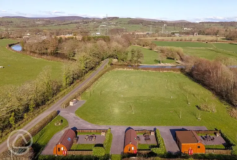 Aerial of the glamping pods, countryside and Lancaster Canal