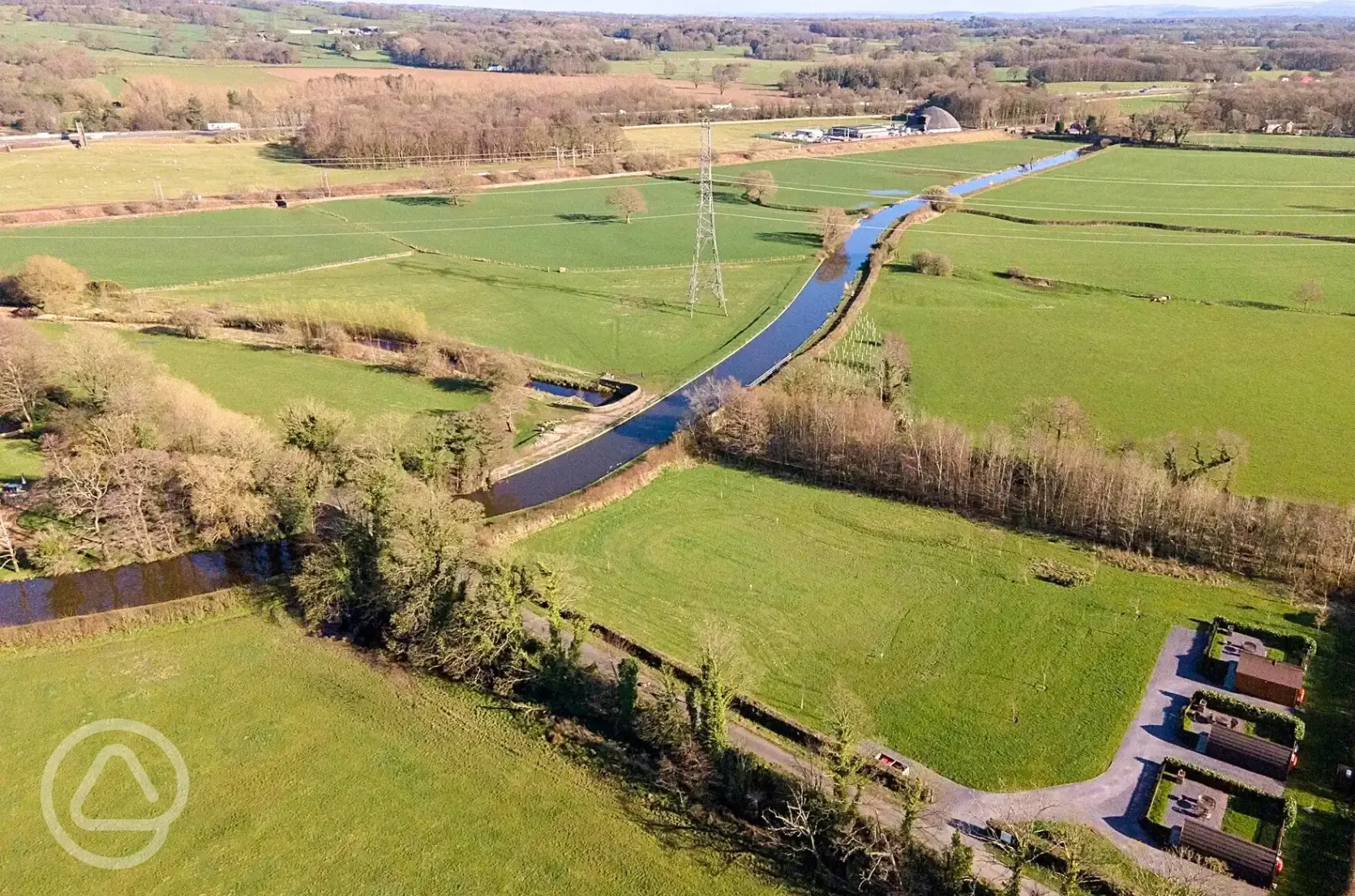 Aerial of the glamping pods, countryside and Lancaster Canal