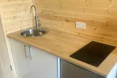 Luxury pod kitchen with a hob, kettle, microwave, fridge/freezer and sink Luxury pod kitchen with a hob, kettle, microwave, fridge/freezer and sink