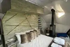 Glamping domes interior with a king bunk bed and a king size bed below Glamping domes interior with a king bunk bed and a king size bed below