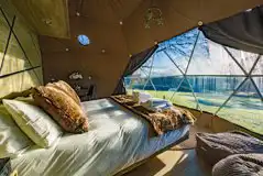 King-sized bed in the glamping dome at Luna Domes at Hoath House King-sized bed in the glamping dome at Luna Domes at Hoath House