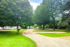 Hardstanding touring pitches with 10 amp hook ups and adjacent grass areas