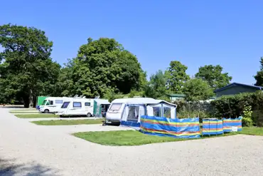 Hardstanding touring pitches with 10 amp hook ups and adjacent grass areas