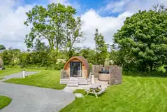 Ensuite glamping pod exterior, with hot tub, decking and outdoor bench seating