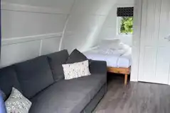Adult only ensuite glamping pod interior with bed and sofa - pet free
