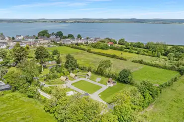 Aerial of the glamping pods, surrounding countryside and the Solway Coast