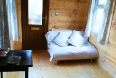 Millie glamping cabin interior and futon bed