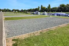 Fully serviced gravel hardstanding pitches (3m x 9m) by the aqua park Fully serviced gravel hardstanding pitches (3m x 9m) by the aqua park