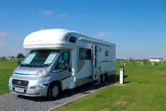 Motorhome on fully serviced gravel hardstanding pitch (16 amp hook up)