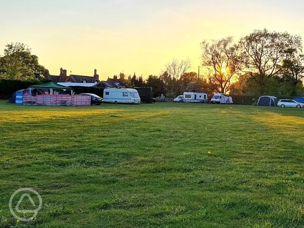 Campers and tourers on the camping field at sunset
