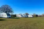 Tourers on electric hardstanding pitches (10m x 10m) at Old Buckenham