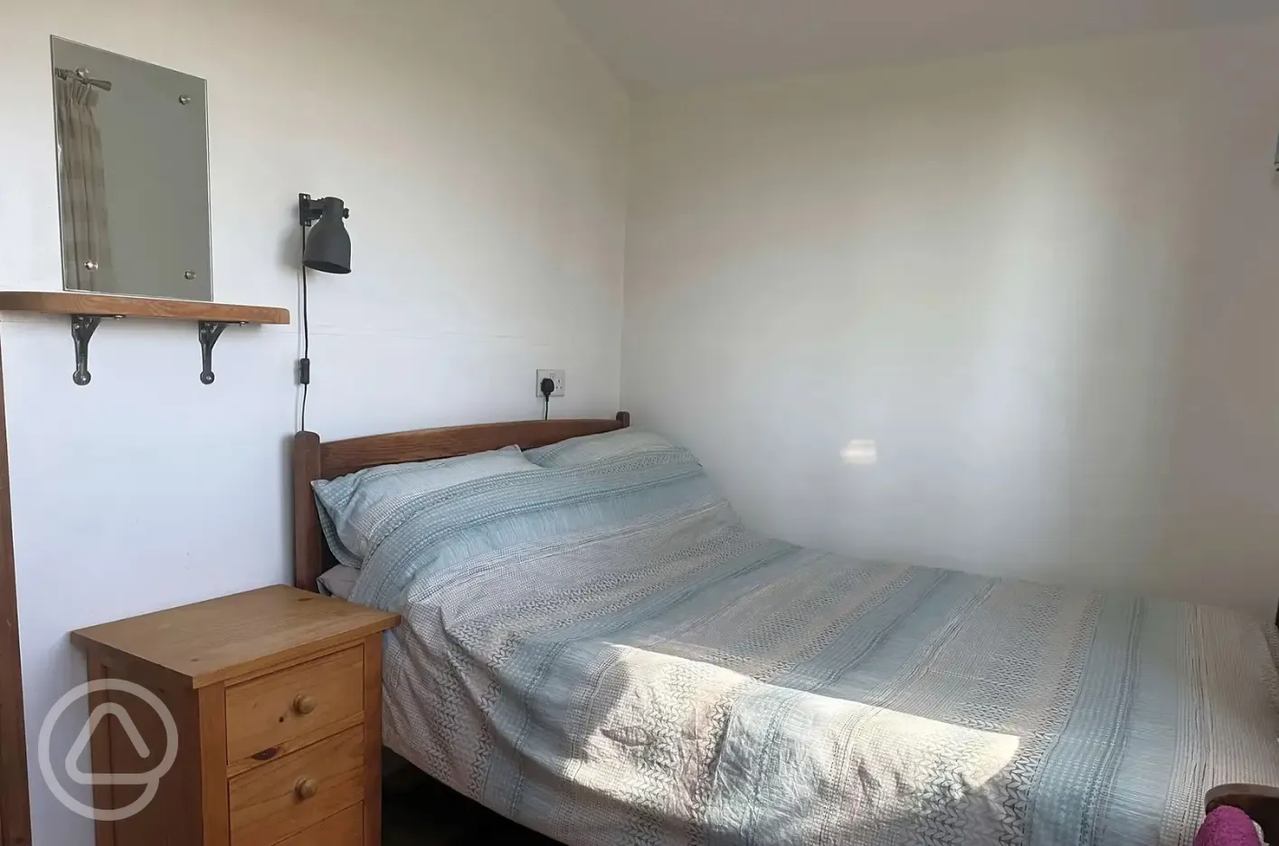 Log glamping cabin double bed