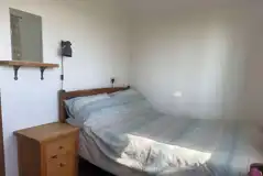 Log glamping cabin double bed