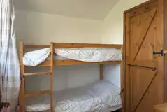 Log glamping cabin bunk bed