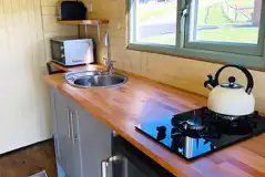 Family glamping pod kitchen area