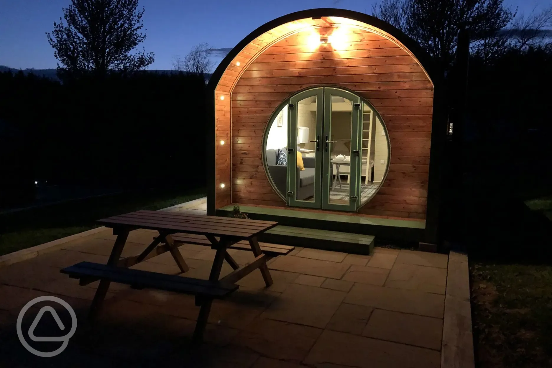 Glamping pod with bunk-bed exterior at night