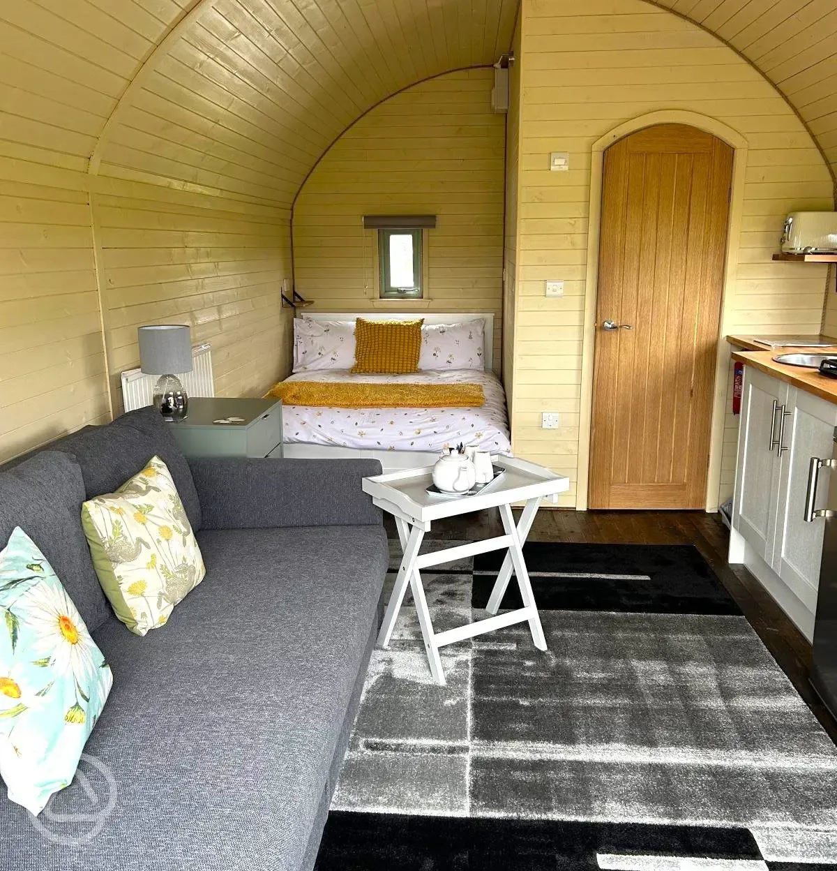 Adult only glamping pod with hot tub interior with double bed, ensuite and sofa
