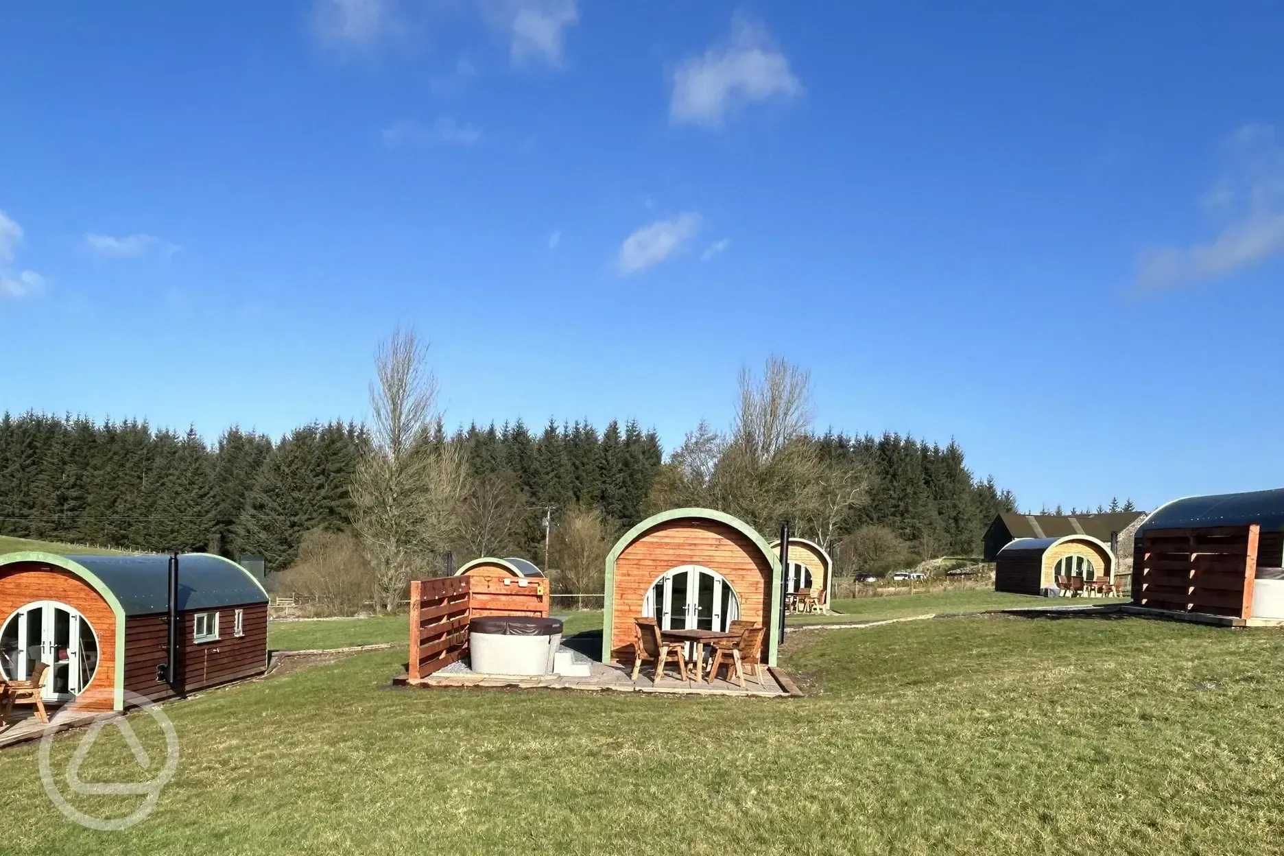 Exterior of Glamping pods with hot tubs and private decking area