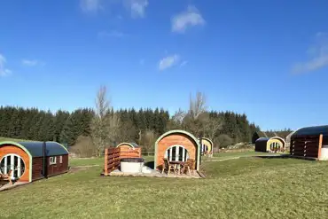 Exterior of Glamping pods with hot tubs and private decking area