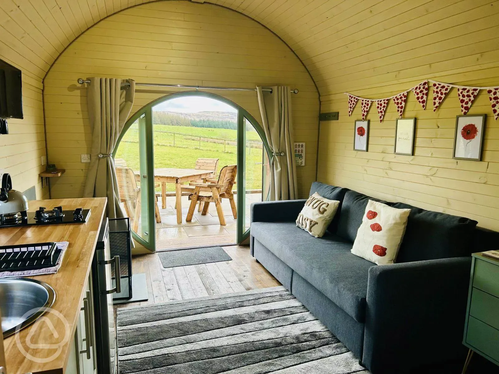 Adult only glamping pod with hot tub interior with sofa, kitchenette and decking