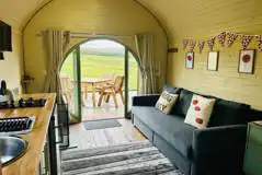 Adult only glamping pod with hot tub interior with sofa, kitchenette and decking Adult only glamping pod with hot tub interior with sofa, kitchenette and decking