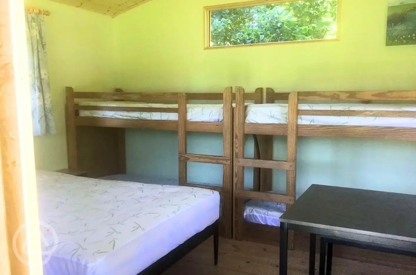 Primrose cabin with a double bed and two bunk beds
