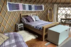 Thistle yurt interior with a double bed (bedding included)