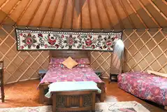 Double bed in the Bramble yurt with bedding provided