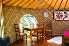 Bramble yurt complete with a dining area and wood burner
