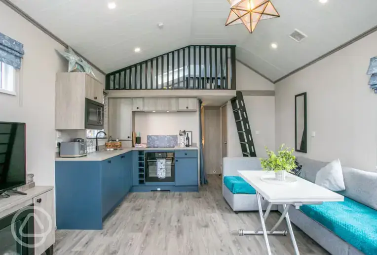 Interior and kitchen with a fridge, microwave, toaster, kettle, sink, hob, oven 