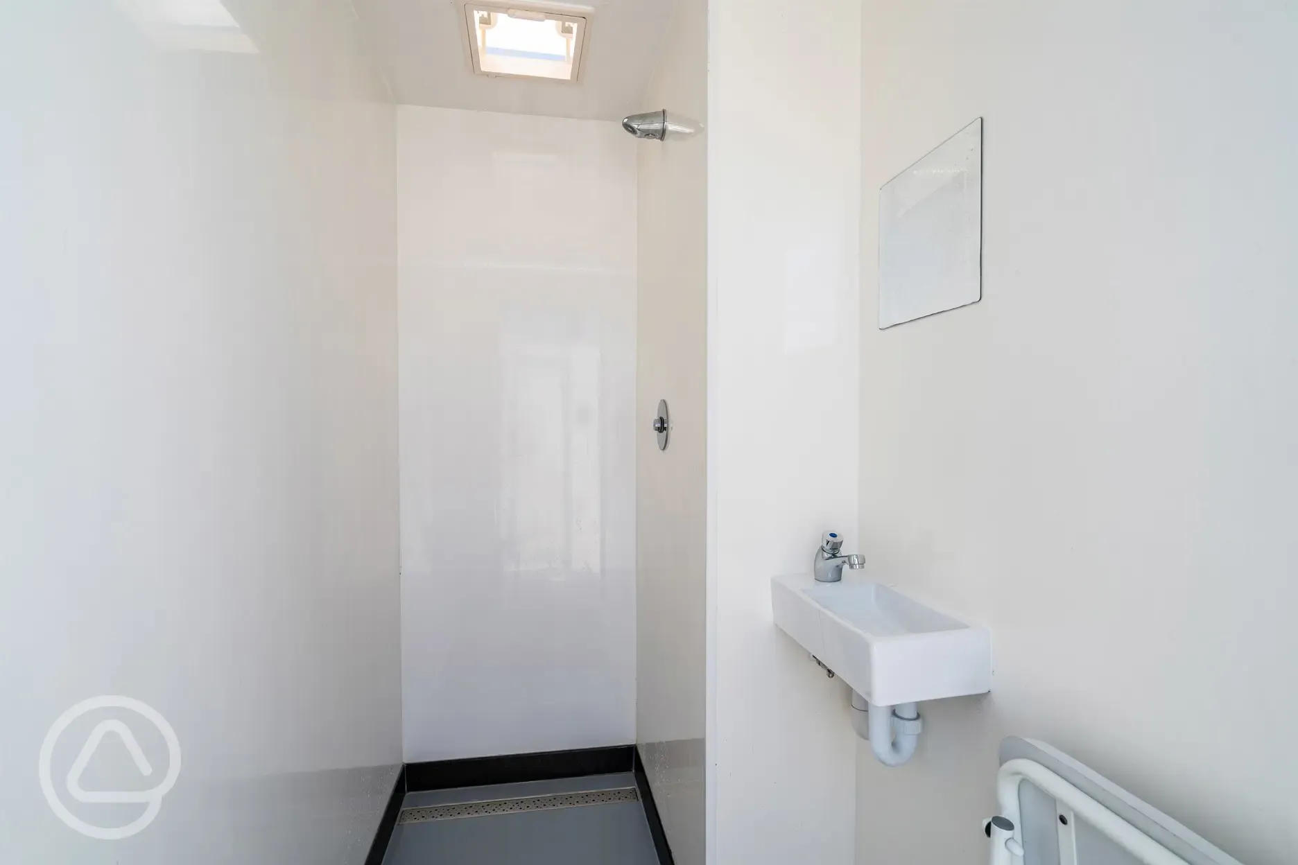 Push button showers with a hand basin and mirror