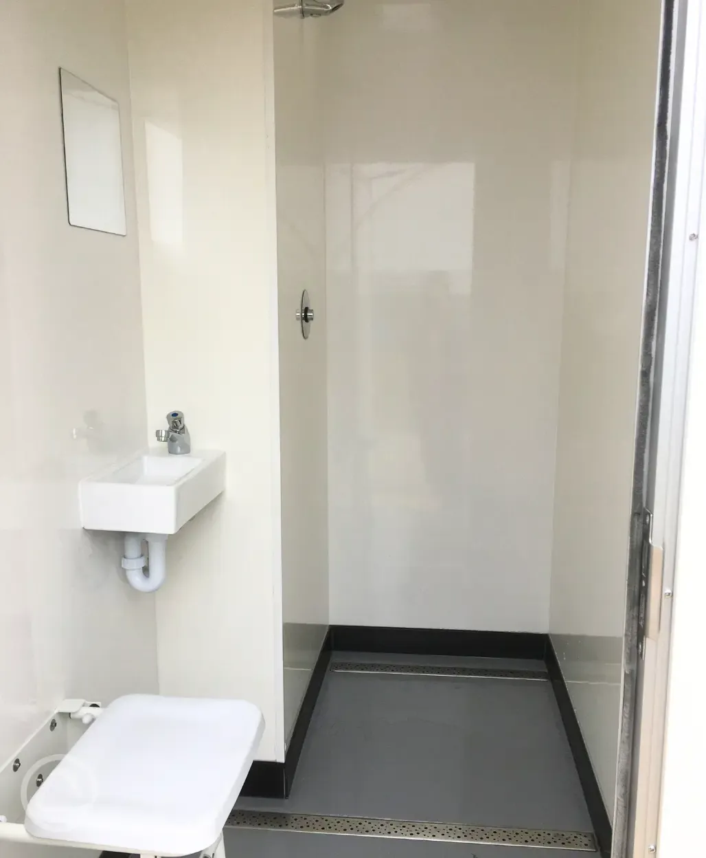 Push button showers with a hand basin, mirror and chair