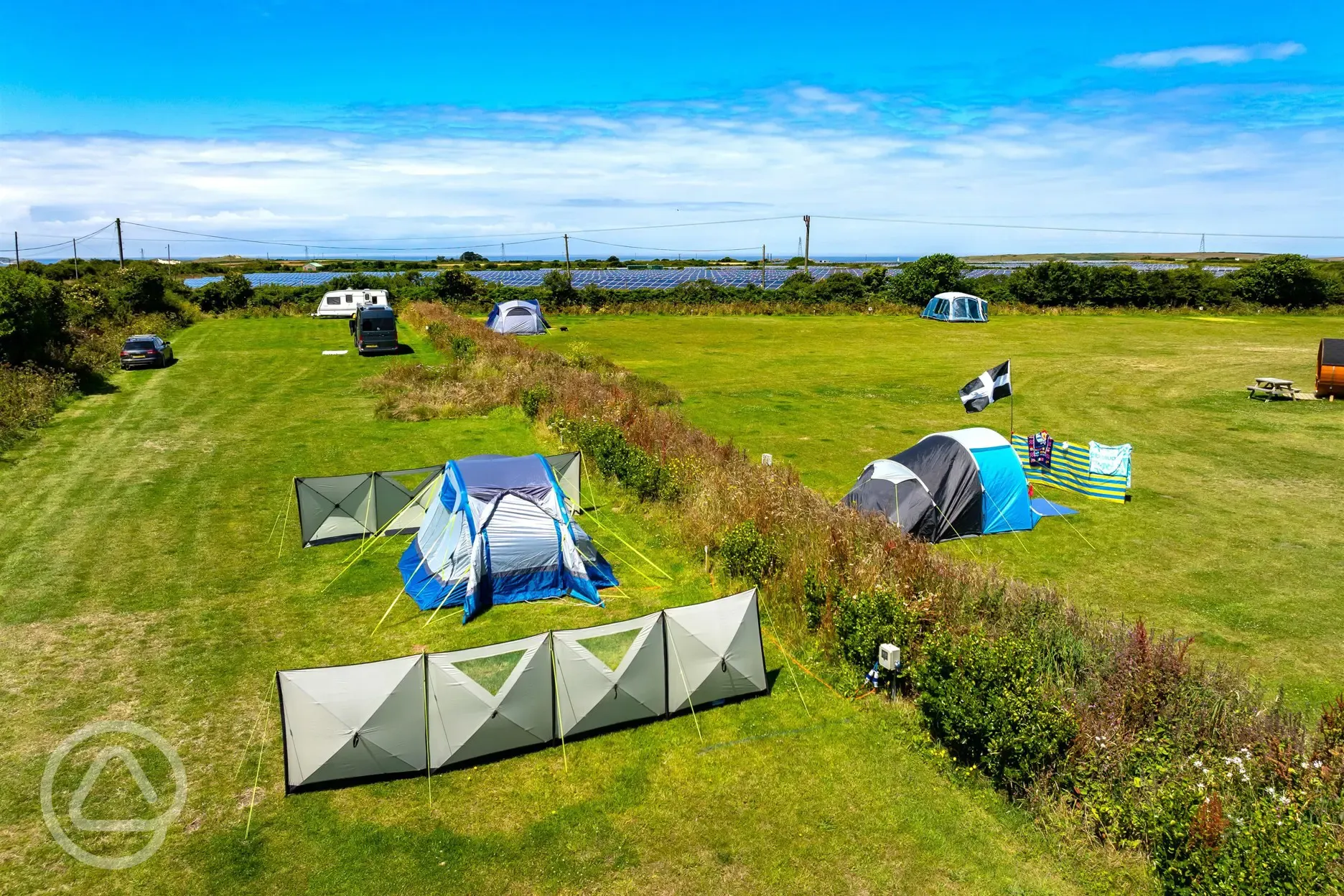 Raised view of the electric grass pitches with hedging between rows