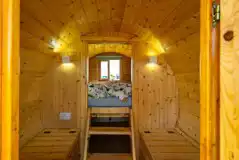 Camping pod interior with a raised bed and bench seating