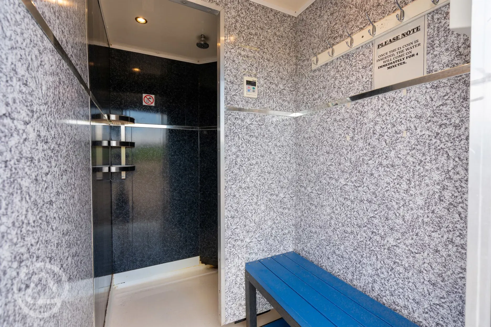 Coin operated showers with hooks and bench seating