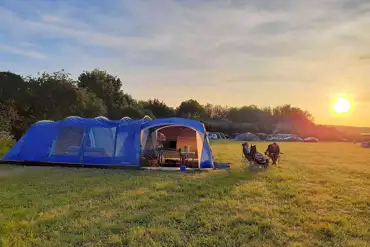 Non electric grass tent pitch at sunset