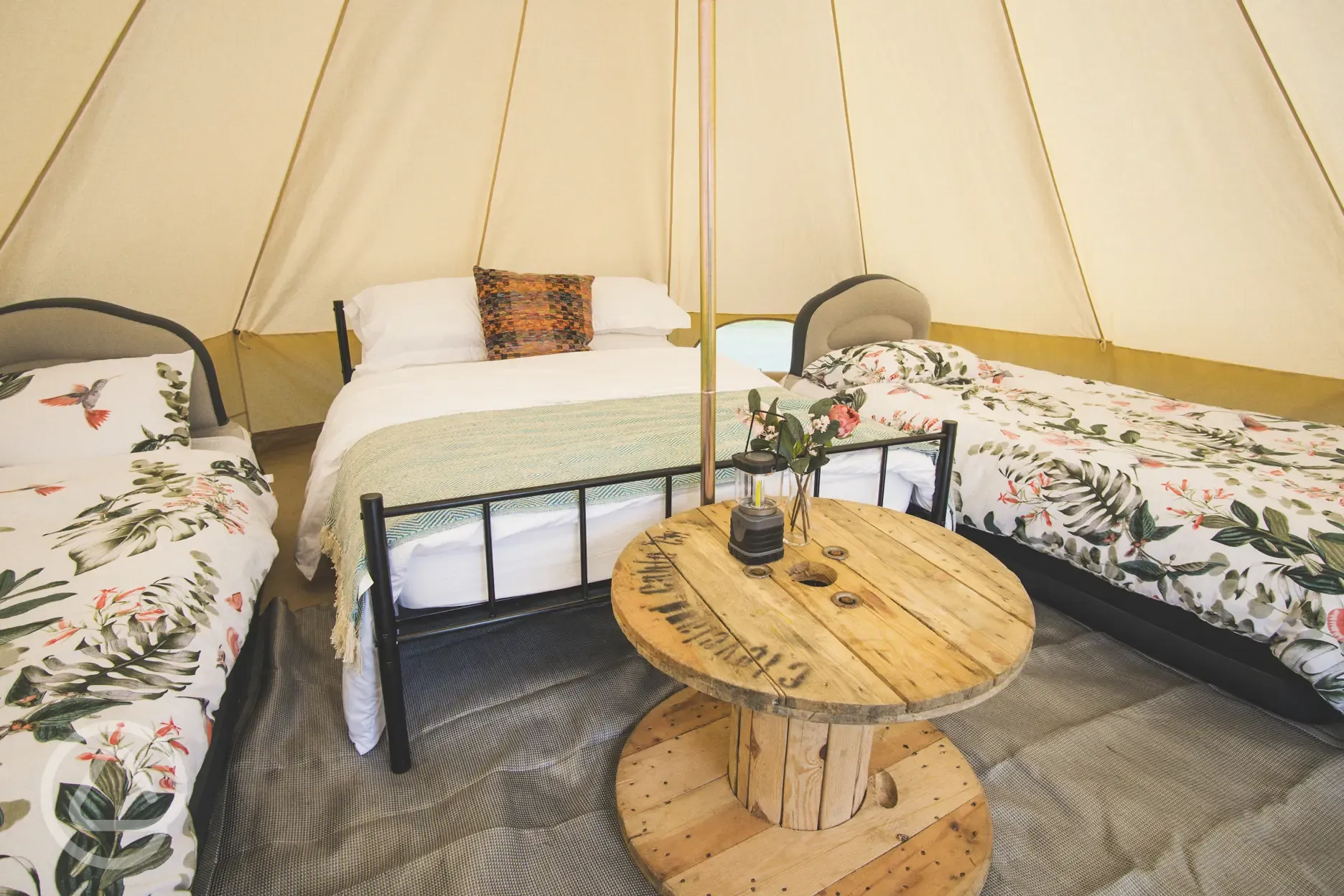 Bell tent double bed and two single beds with bedding