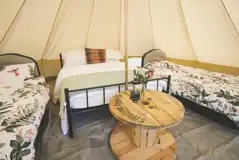 Bell tent double bed and two single beds with bedding
