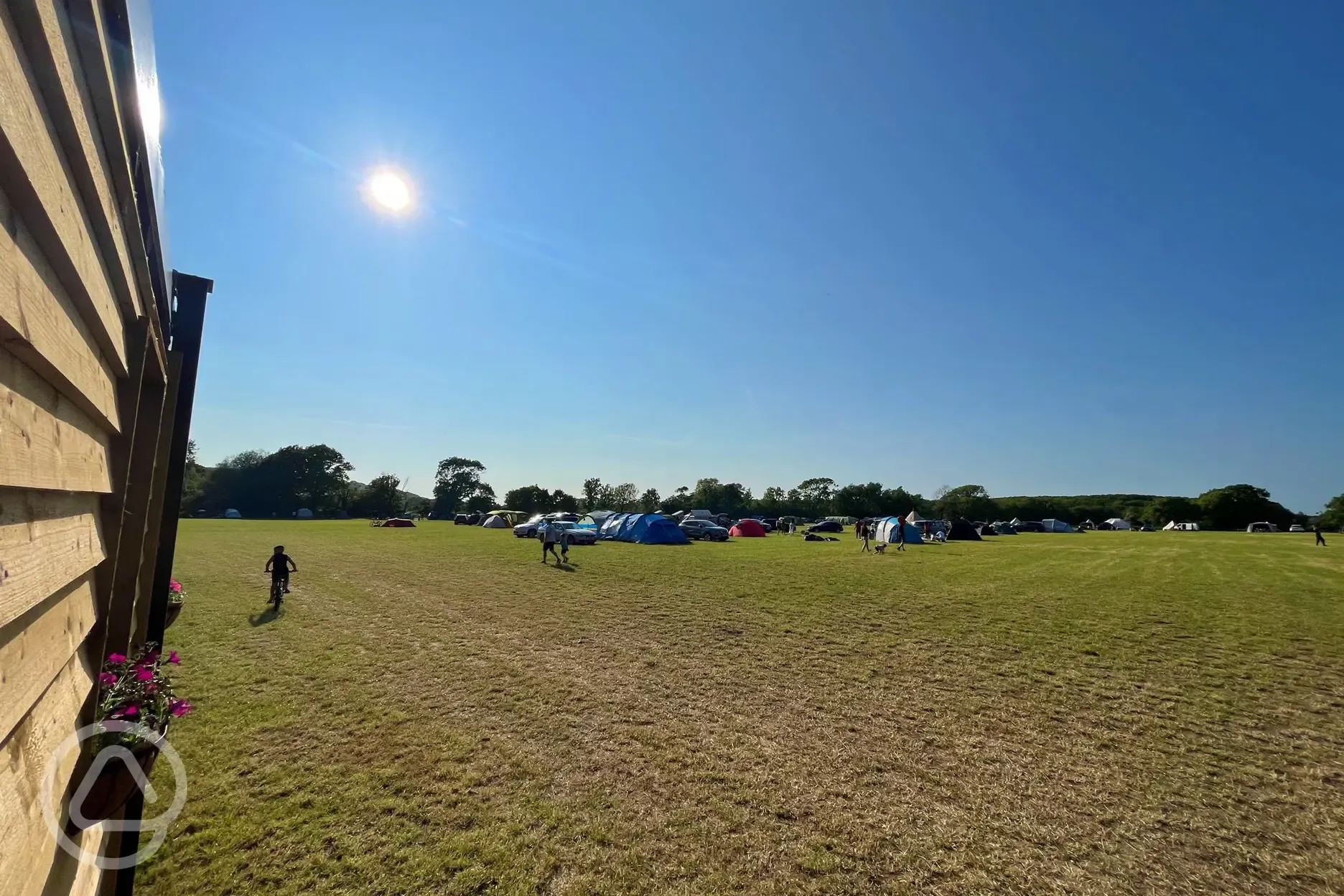 Non electric grass pitches with parking spaces beside tents