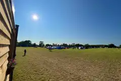 Non electric grass pitches with parking spaces beside tents Non electric grass pitches with parking spaces beside tents