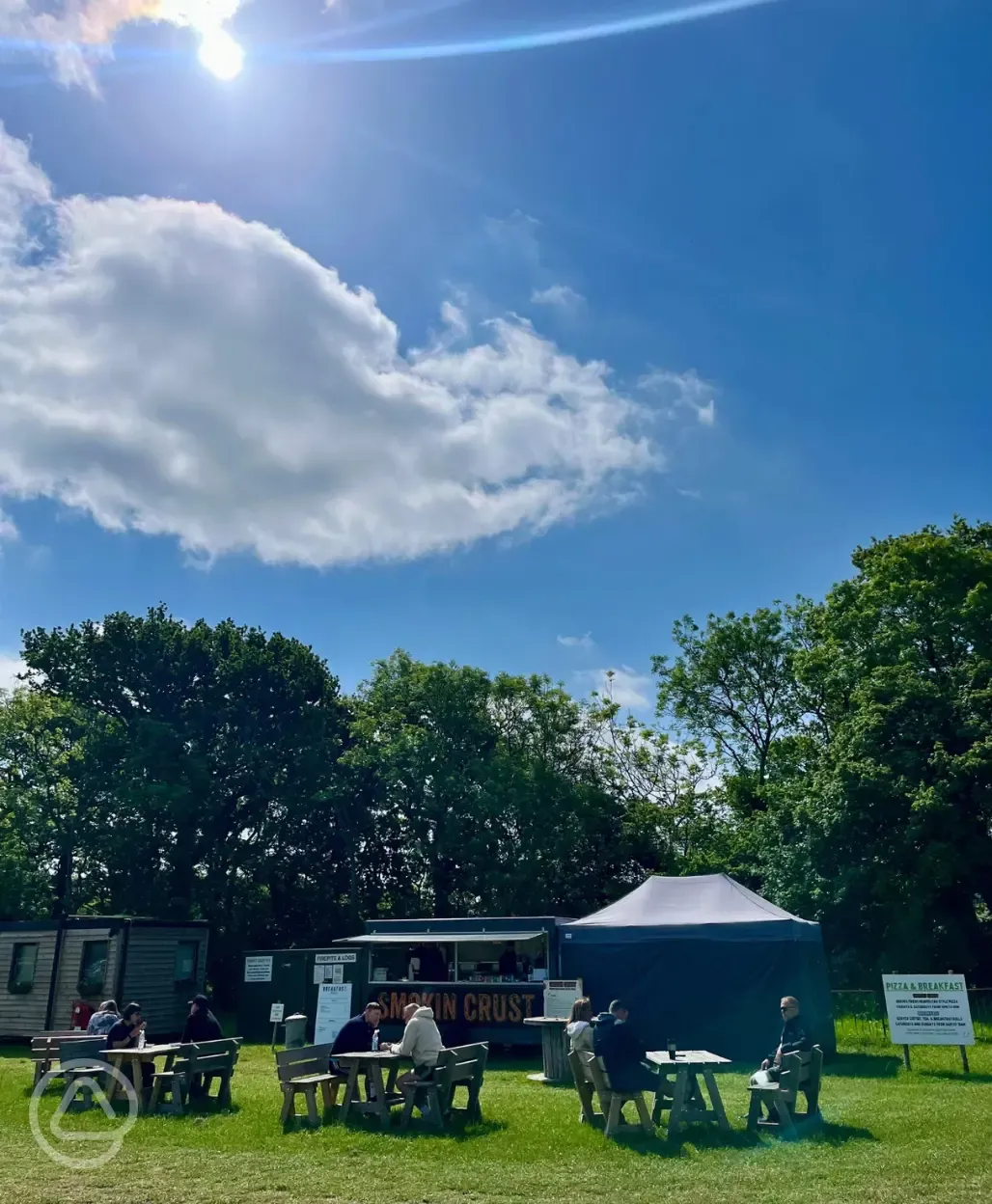 Onsite food truck outdoor seating at Bramley Park Camping during peak season