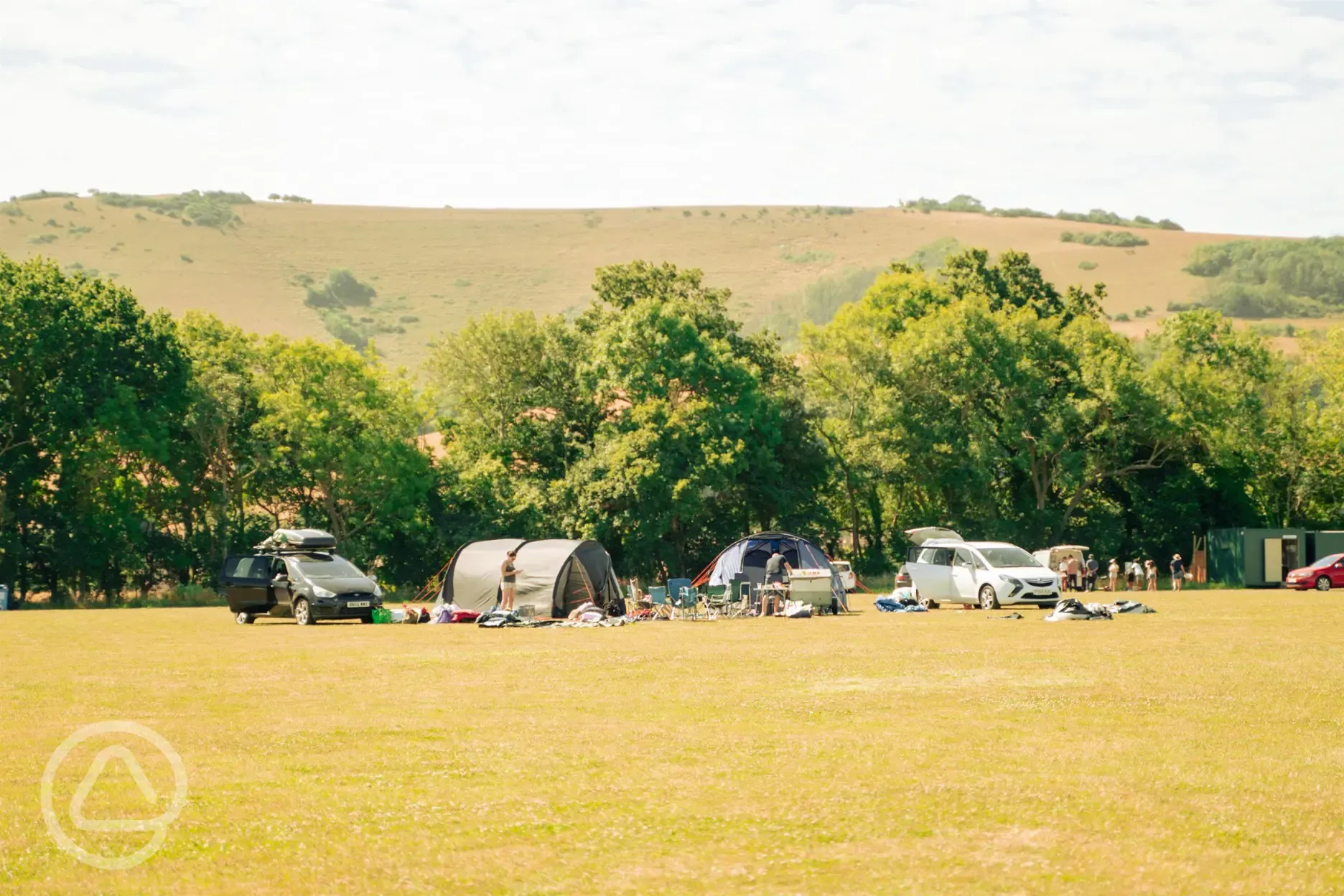 Non electric grass pitches with parking spaces beside tents